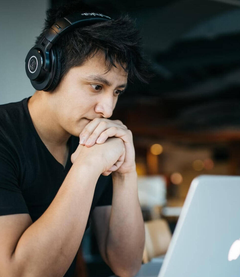 A man watching a training video on a laptop.